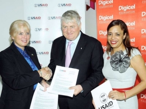 Denis O'Brien, founder and chair of the Digicel Group, seals the deal with Denise Herbol (left), mission director of the United States Agency for International Development, while Samantha Chantrelle, executive director of the Digicel Foundation, looks on. (Photo: Contributed to the Gleaner)