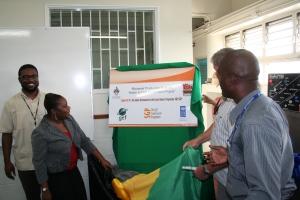 Ms. Hyacinth Douglas, National Coordinator of the Global Environment Facility's Small Grants Program (GEF SGP) in Jamaica, unveils the project, while Senior Energy Engineer at the Ministry of Science, Technology, Energy & Mining Mr. Gerald Lindo (left) looks on. (Photo: Youth Crime Watch of Jamaica)