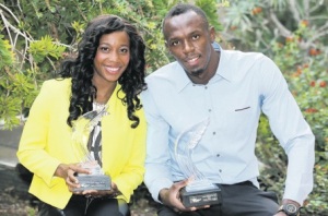 MONACO — Jamaican sprinters Usain Bolt and Shelly-Ann Fraser-Pryce hold their International Athletics Foundation 2013 Athlete of the Year Awards after a press conference. Don't they look lovely. (PHOTO: AP) 