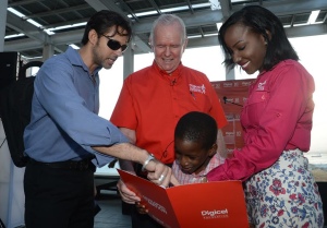 Special Needs student Jadane Martin (second right) from Early Stimulation Plus, reading to (from left) Brian Schmidt, Marketing Manager, Irie FM; Major General Robert Neish, Digicel Foundation Vice-Chairman and Judine Hunter, Special Needs Programme Manager, Digicel Foundation. Occasion was the official launch of the Digicel Foundation 5k Run/Walk on Wednesday, August 13. (Photo: Digicel Foundation)