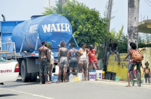 Lining up for water from a truck in Annotto Bay, St. Mary. (Photo: Everard Owen/Jamaica Observer)