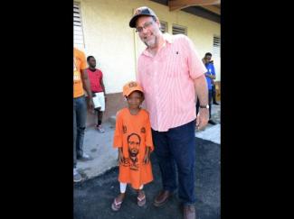 Mark Golding with a young PNP supporter in St. Andrew South.