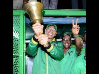 Prime Minister Andrew Holness ringing the Jamaica Labour Party's bell of victory with winning candidate Dr Norman Dunn for St Mary South East. (Photo: Ricardo Makyn/Gleaner)